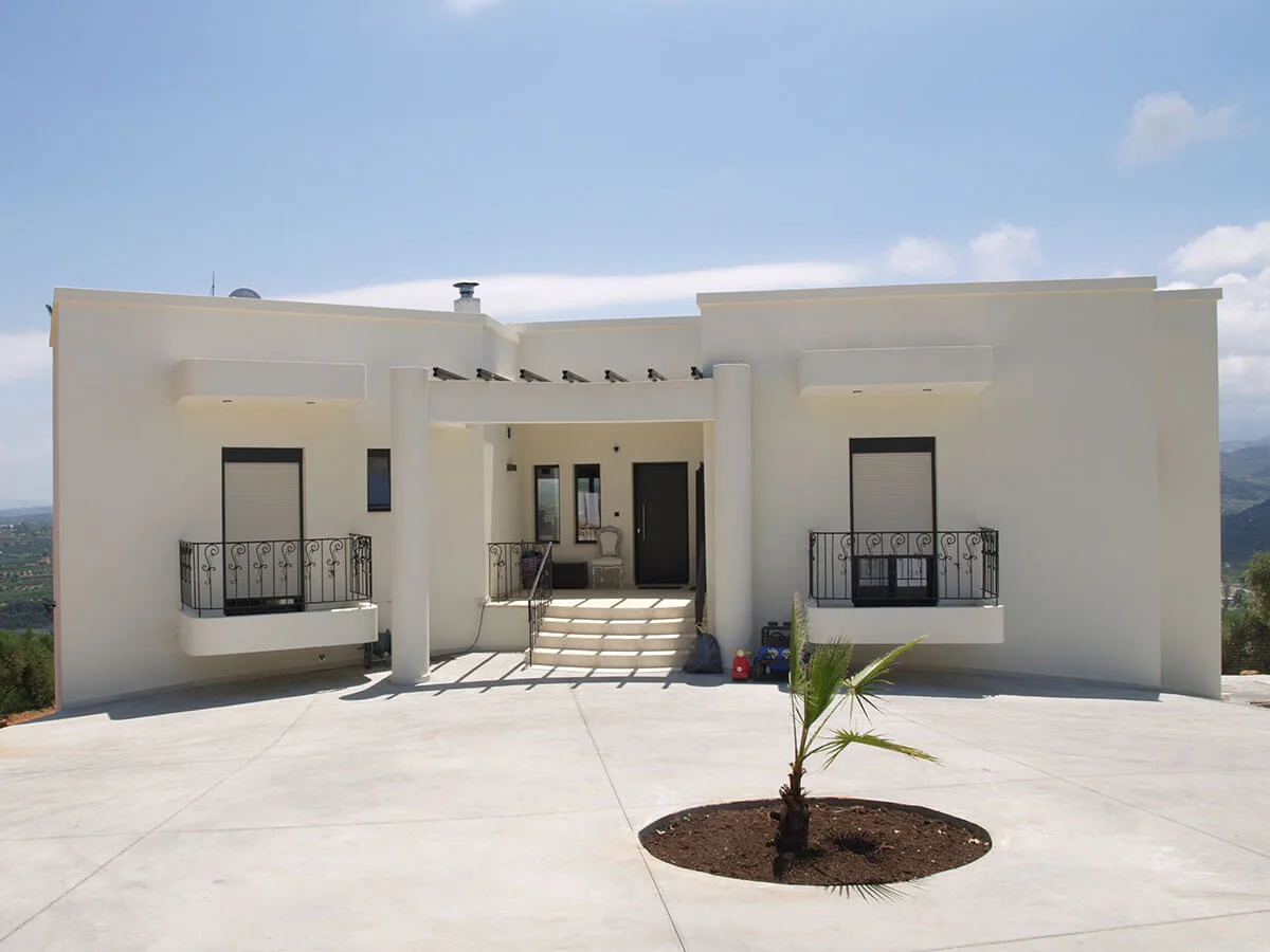 Front view of a fully renovated two-story house with modern design and swimming pool in Polemarchi, Crete