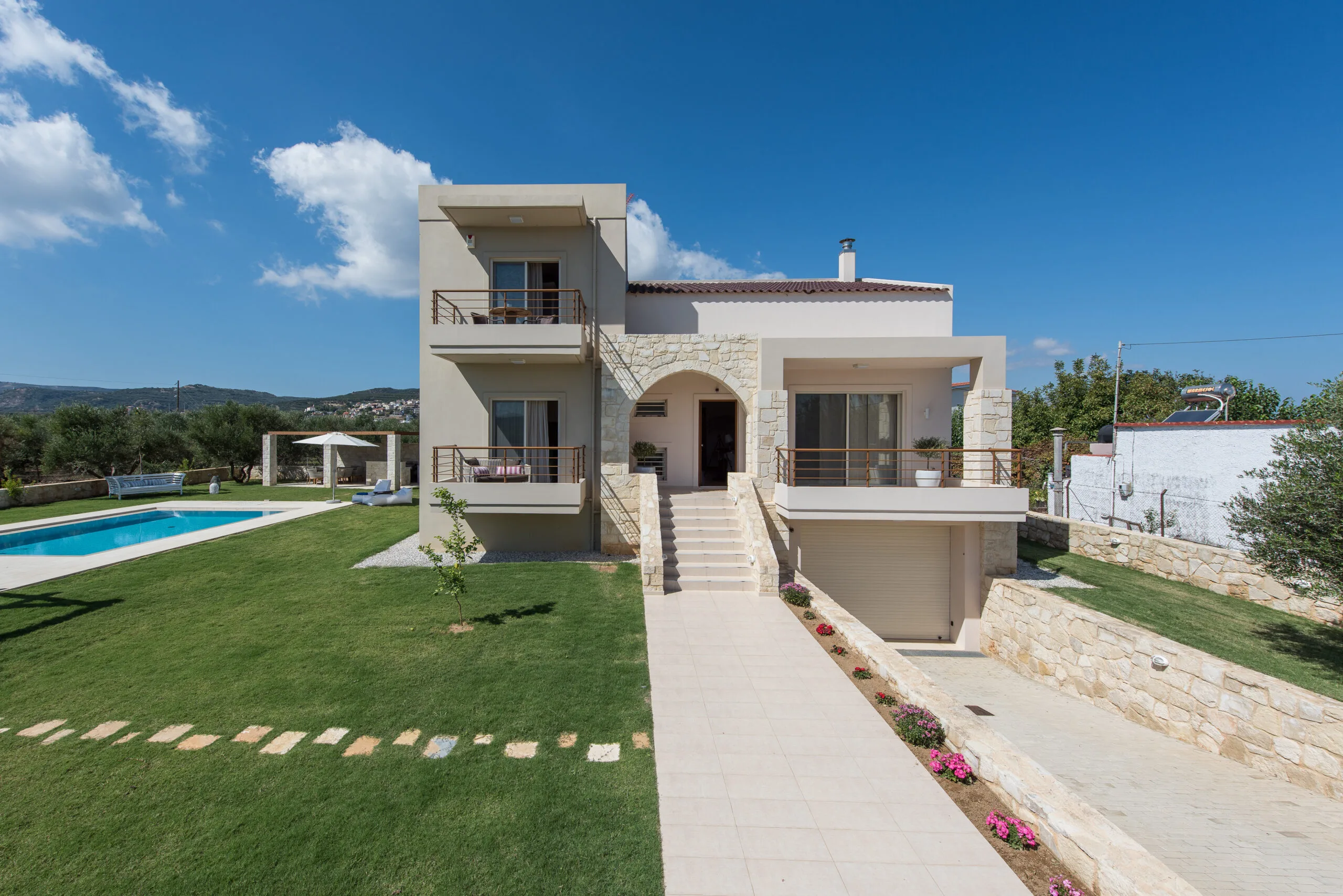 Front facade of Minos Dream luxury villa with basement and pool in Minothiana